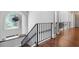 Staircase with hardwood floors, black iron railing, and white columns at 948 Saint Lyonn Cts, Marietta, GA 30068