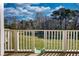 View of the grassy backyard featuring trees and sky from the vantage point of a deck at 2002 Orchard Terrace, Loganville, GA 30052