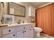 Well-lit bathroom with a white vanity, framed mirror, and neutral color scheme at 2002 Orchard Terrace, Loganville, GA 30052
