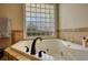 This bathtub sits under a window block allowing tons of natural light in the space at 2002 Orchard Terrace, Loganville, GA 30052