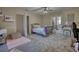 Bright bedroom featuring a vanity, a bed with a blue and pink comforter, and neutral walls at 2002 Orchard Terrace, Loganville, GA 30052