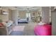 Large bedroom with a bed, vanity, pink beanbag, and ample space at 2002 Orchard Terrace, Loganville, GA 30052