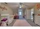 This bedroom is spacious, and has pink accents and a large flower decor piece on the wall at 2002 Orchard Terrace, Loganville, GA 30052