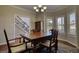 Dining room with dark wood table and chairs, a buffet, and natural light from the windows at 2002 Orchard Terrace, Loganville, GA 30052