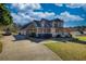 Charming two-story home with an attached garage and well-manicured lawn under a blue sky at 2002 Orchard Terrace, Loganville, GA 30052