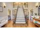 Grand foyer with a staircase, hardwood floors, and decorative lighting fixtures at 2002 Orchard Terrace, Loganville, GA 30052