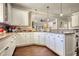 Bright kitchen with white cabinets, granite counters, and hardwood floors at 2002 Orchard Terrace, Loganville, GA 30052