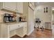 Bright kitchen features a coffee bar with upper and lower cabinets and wooden floors at 2002 Orchard Terrace, Loganville, GA 30052
