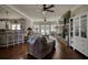 Open living room with stone fireplace, ceiling fans, and connection to the kitchen at 2002 Orchard Terrace, Loganville, GA 30052