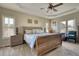 This main bedroom has three windows for ample light and a wooden bed frame at 2002 Orchard Terrace, Loganville, GA 30052