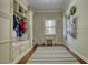 Mudroom with storage cabinets, coat hooks, a bench and a small table with chairs at 2002 Orchard Terrace, Loganville, GA 30052