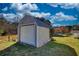 Functional outbuilding featuring a roll-up door, offering additional storage or workspace at 2002 Orchard Terrace, Loganville, GA 30052