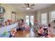 Playroom filled with toys featuring hardwood floors, bright windows and a ceiling fan at 2002 Orchard Terrace, Loganville, GA 30052