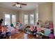 Playroom with hardwood floors, many windows, ceiling fan, and a patio door at 2002 Orchard Terrace, Loganville, GA 30052