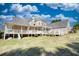Expansive rear exterior featuring a multi-level deck and covered patio, set on a grassy lawn at 2002 Orchard Terrace, Loganville, GA 30052