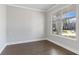 Well-lit bedroom features a large window with views, and wood flooring at 3925 Cordano Ln, Lawrenceville, GA 30044