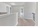 Upstairs hallway view with carpet and iron railing leading to a bathroom at 3925 Cordano Ln, Lawrenceville, GA 30044