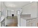 Open-concept view with hardwood floors, white trim, and kitchen features a view to the living room at 3925 Cordano Ln, Lawrenceville, GA 30044