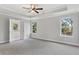 Spacious main bedroom featuring neutral colors, and two windows at 3925 Cordano Ln, Lawrenceville, GA 30044