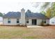 Home's rear exterior featuring a patio and expansive lawn area at 4580 Darrowby Dr, Powder Springs, GA 30127