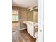 Bathroom features vanity with sink, toilet and view to the living area at 4580 Darrowby Dr, Powder Springs, GA 30127