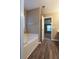 A bathroom with soaking tub and wood flooring at 4580 Darrowby Dr, Powder Springs, GA 30127