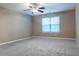 Spacious bedroom features ceiling fan, neutral colored walls and carpet flooring at 4580 Darrowby Dr, Powder Springs, GA 30127