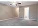Large bedroom features a ceiling fan, neutral walls, carpet and an adjoining bathroom at 4580 Darrowby Dr, Powder Springs, GA 30127