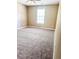 A bedroom with ceiling fan, large window, and carpet at 4580 Darrowby Dr, Powder Springs, GA 30127