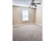 A bedroom with ceiling fan, large window, and carpet at 4580 Darrowby Dr, Powder Springs, GA 30127