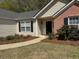 Charming front entrance featuring well-maintained landscaping at 4580 Darrowby Dr, Powder Springs, GA 30127