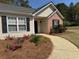 Front entrance with black shutters, brick accents, and landscaping at 4580 Darrowby Dr, Powder Springs, GA 30127