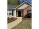 Inviting front entrance with a well-lit pathway and manicured flowerbeds at 4580 Darrowby Dr, Powder Springs, GA 30127