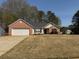Charming single-story home with a brick and siding exterior, featuring a well-maintained lawn at 4580 Darrowby Dr, Powder Springs, GA 30127