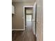 Neutral colored hallway features wood-look flooring and an entrance to the home's living area at 4580 Darrowby Dr, Powder Springs, GA 30127