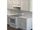 Modern kitchen features white appliances, quartz countertops and light wood-look floors at 4580 Darrowby Dr, Powder Springs, GA 30127