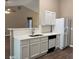 Modern kitchen features white cabinets, stainless steel appliances and quartz countertops at 4580 Darrowby Dr, Powder Springs, GA 30127