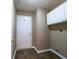 Laundry room has storage cabinet, neutral paint, and wood-look flooring throughout at 4580 Darrowby Dr, Powder Springs, GA 30127