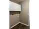 Laundry room boasts storage, neutral paint, and wood-look flooring throughout at 4580 Darrowby Dr, Powder Springs, GA 30127