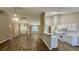 Open-concept living room flows into kitchen, showcasing high ceilings and wood-look flooring throughout at 4580 Darrowby Dr, Powder Springs, GA 30127