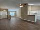 Open-concept living area with wood floors, a ceiling fan, and access to kitchen and dining at 4580 Darrowby Dr, Powder Springs, GA 30127