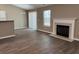 Living room showcases fireplace, sliding door, and wood-look flooring throughout at 4580 Darrowby Dr, Powder Springs, GA 30127