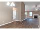 View of living room showcasing vaulted ceiling, fireplace, wood-look flooring, and neutral paint at 4580 Darrowby Dr, Powder Springs, GA 30127