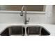 Close up of stainless steel kitchen sink with gooseneck faucet and white quartz countertops at 4580 Darrowby Dr, Powder Springs, GA 30127