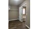 A spacious walk-in closet with wood floor and metal shelving looking into bathroom at 4580 Darrowby Dr, Powder Springs, GA 30127