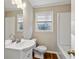 Well-lit bathroom with a combination tub and shower and a classic vanity at 1237 Samuel St, Marietta, GA 30008