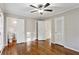 Bright bedroom featuring hardwood floors, ceiling fan, and access to a bathroom at 1237 Samuel St, Marietta, GA 30008