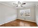 Comfortable bedroom featuring hardwood floors, a ceiling fan, and large windows at 1237 Samuel St, Marietta, GA 30008