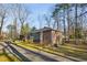 Quaint brick home set back from the road, featuring a side porch and mature trees at 1237 Samuel St, Marietta, GA 30008