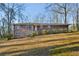 Charming two-story brick home with a manicured lawn and mature trees in a peaceful setting at 1237 Samuel St, Marietta, GA 30008